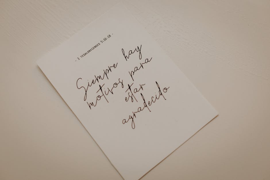 Minimalist photo of an inspirational calligraphy note on white paper.