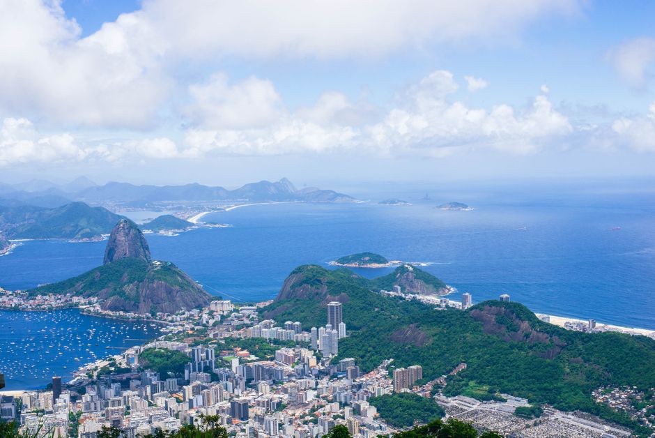 A breathtaking aerial view of Rio de Janeiro, featuring the iconic Sugarloaf Mountain and stunning coastlines