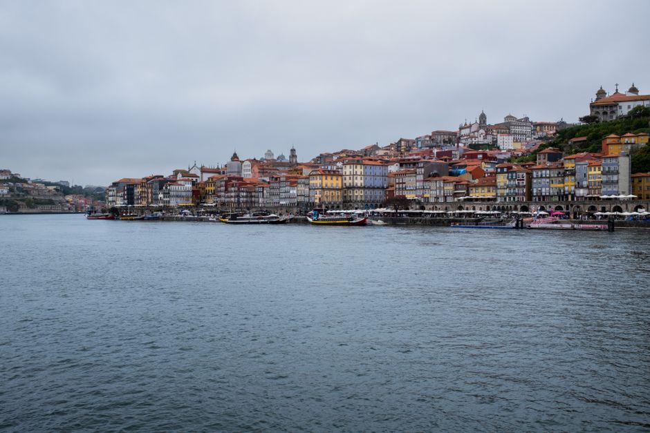 A picturesque riverside view of Porto, featuring colorful historic buildings along the Douro River