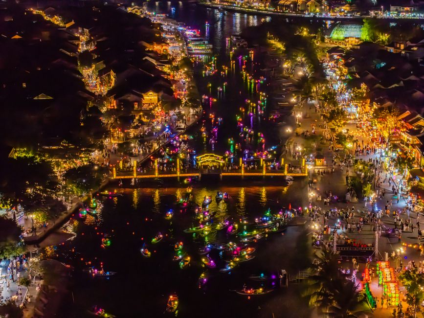 A vibrant aerial shot of Hội An's lantern festival, showcasing colorful lights and bustling waterfront