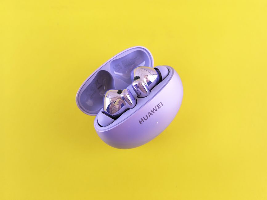 Modern purple earbuds in a case on vibrant yellow background.