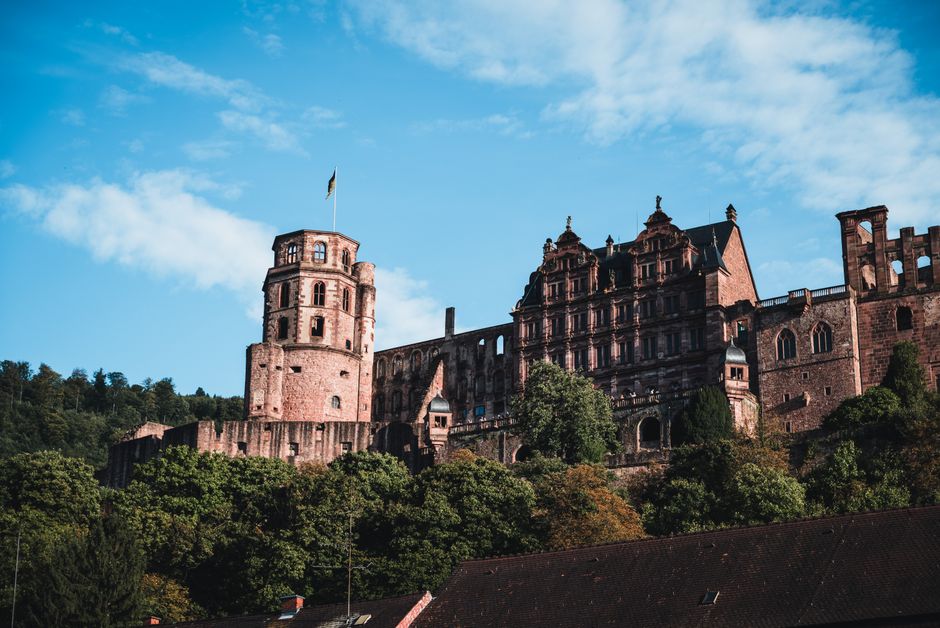 Beautiful angle of Heidelberg Castle with lush trees under a vibrant sky