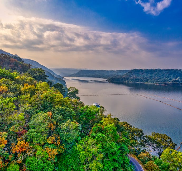 Captivating aerial view of a serene lake surrounded by lush forests in Purwakarta, West Java.