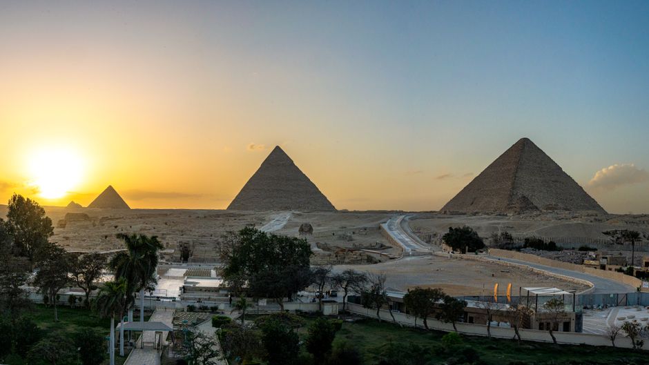 Breathtaking view of the Pyramids of Giza at sunset, capturing ancient history and stunning landscape