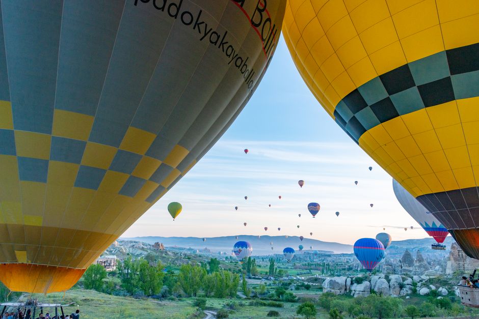 Captivating view of hot air balloons floating over Cappadocia's unique landscape at sunrise