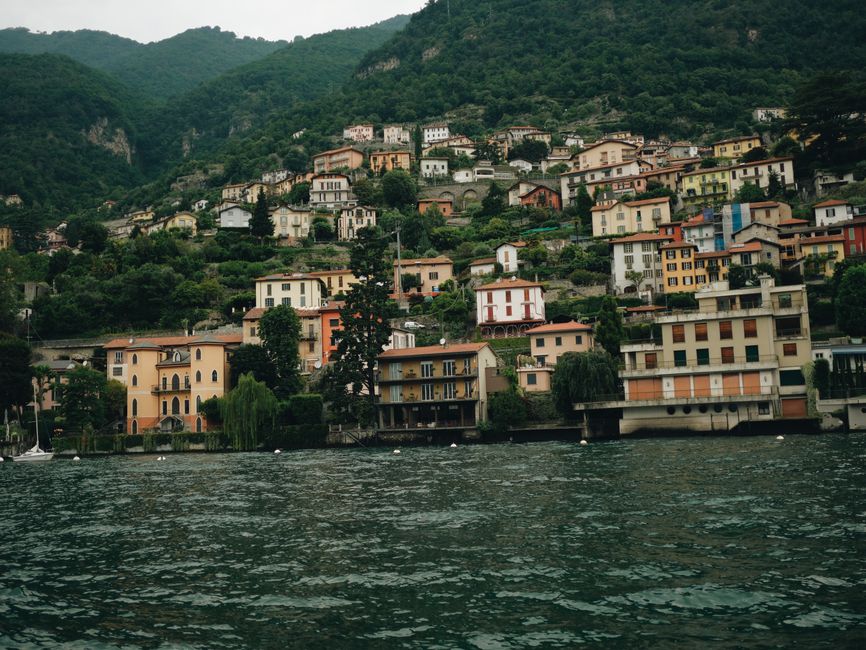 Charming hillside village on Lake Como's shore in Lombardy, Italy, showcasing colorful architecture and lush g