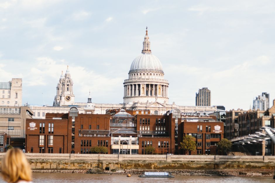View of St. Paul's Cathedral in London across the River Thames on a clear day.
