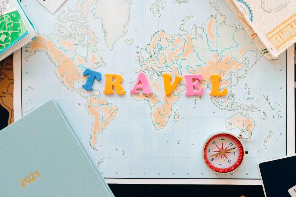 Flat lay of a map with colorful letters 