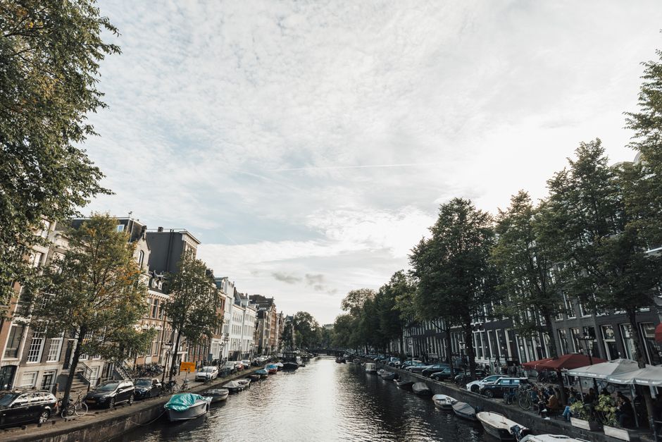 Tranquil canal view with charming boats and historic architecture, ideal for travel inspiration.