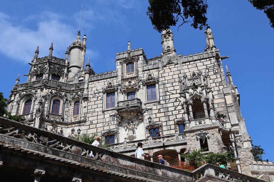 Explore the intricate architecture of a Gothic Revival building in Sintra, Portugal, under a clear blue sky