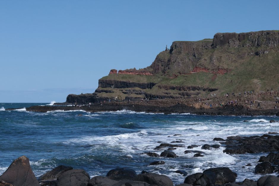 Explore the rugged coastline of Giant's Causeway in Northern Ireland with its stunning basalt columns and wave