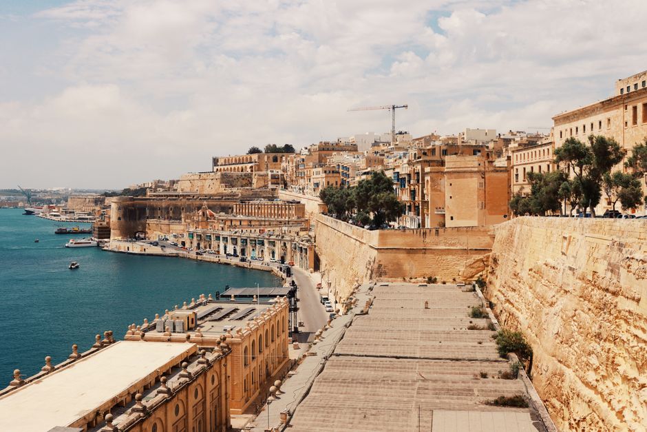 Explore Valletta's stunning waterfront with historic architecture and the serene harbor view