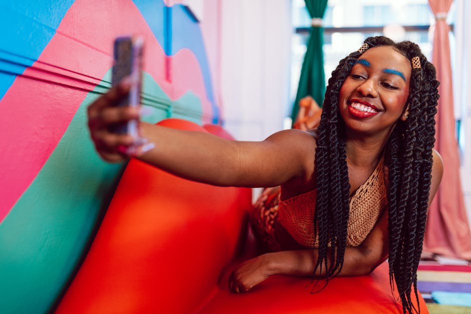 Cheerful woman taking a selfie on a bright, multicolored couch indoors.