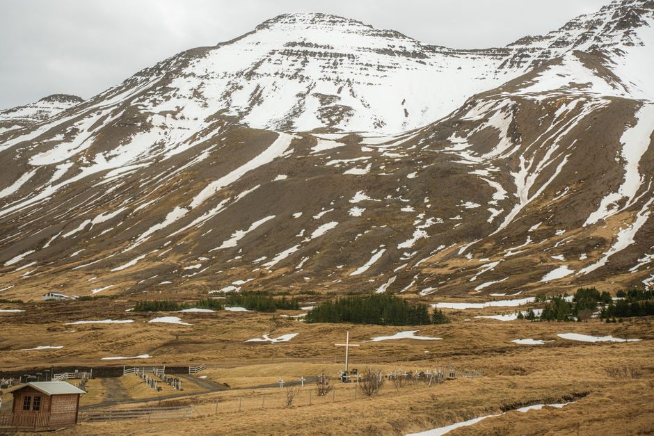 Snow-covered mountains with rugged terrain in rural Iceland.