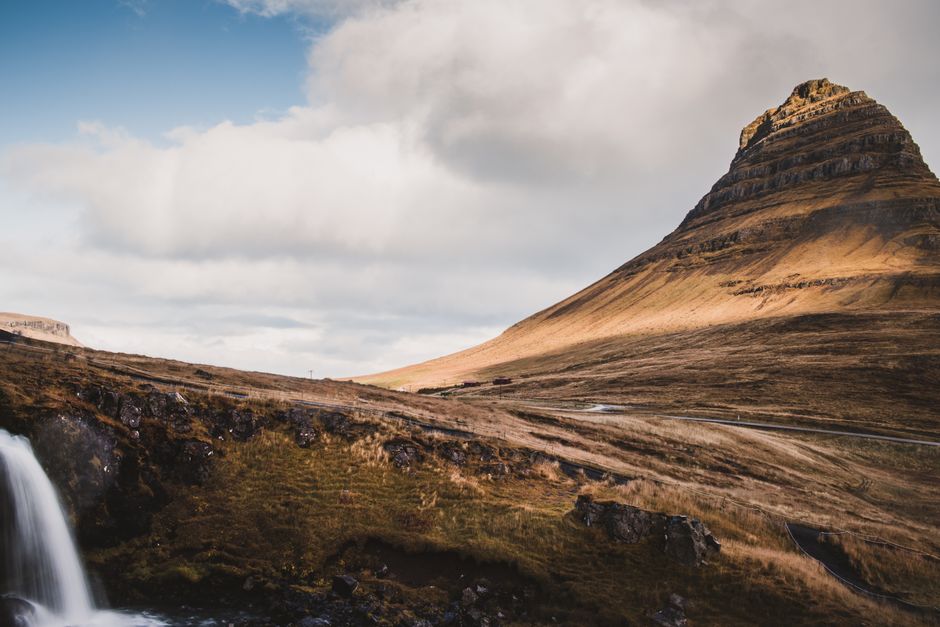 Dramatic landscape of Kirkjufell Mountain with waterfall in Iceland, ideal for nature themes.