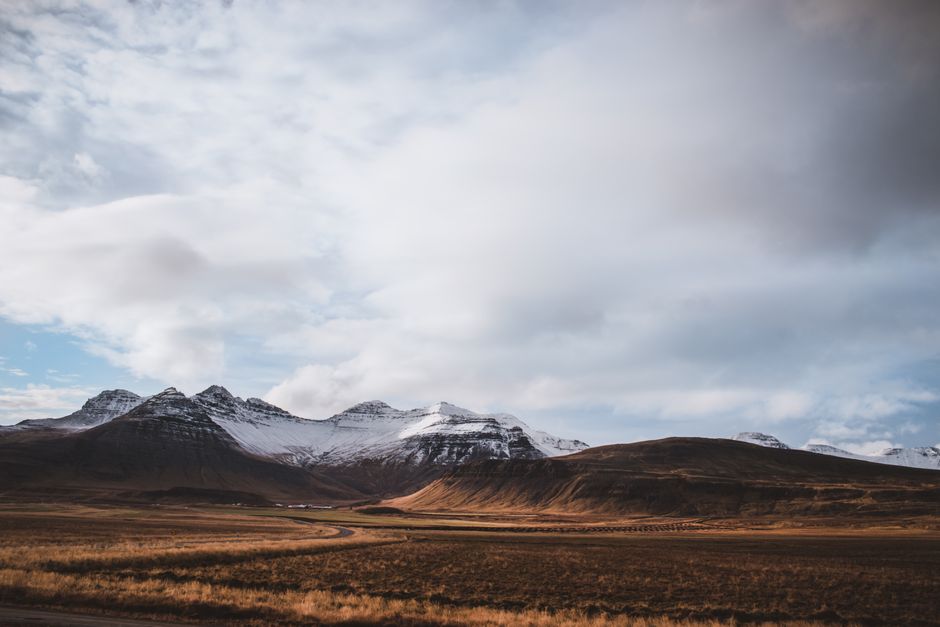Breathtaking view of snow-capped mountains in Iceland under a cloudy sky.