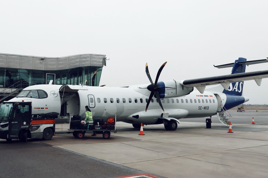 SAS aircraft on the tarmac at Gothenburg Airport in Sweden with service crew.