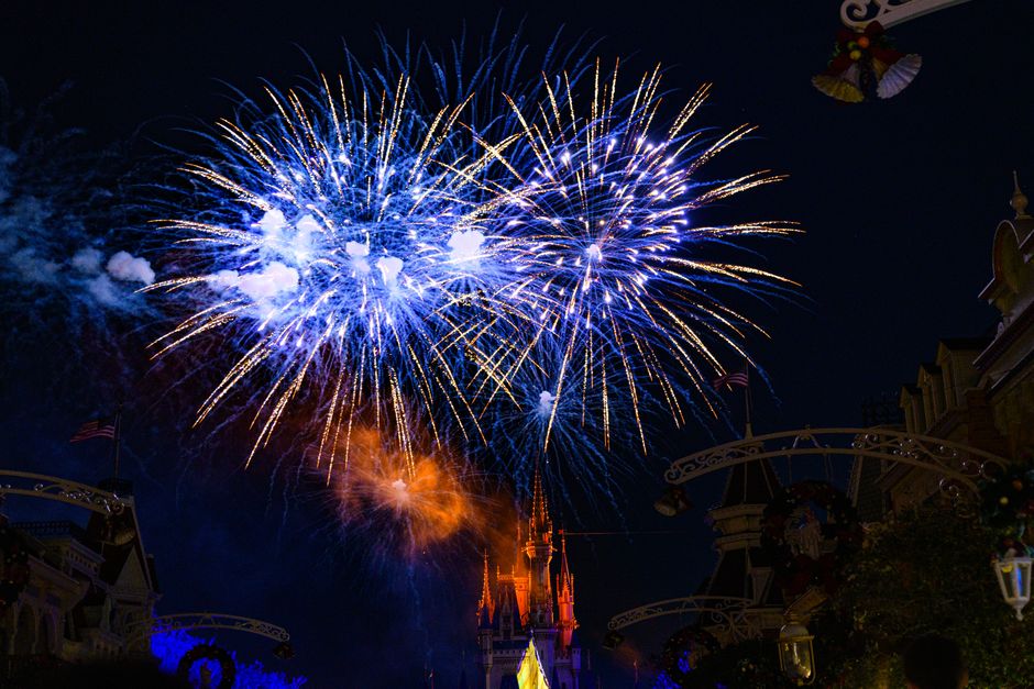 Vibrant fireworks light up the night sky over a famous castle in Florida.