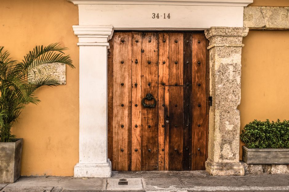 Rustic wooden door in a colonial-style building in Cartagena, Colombia