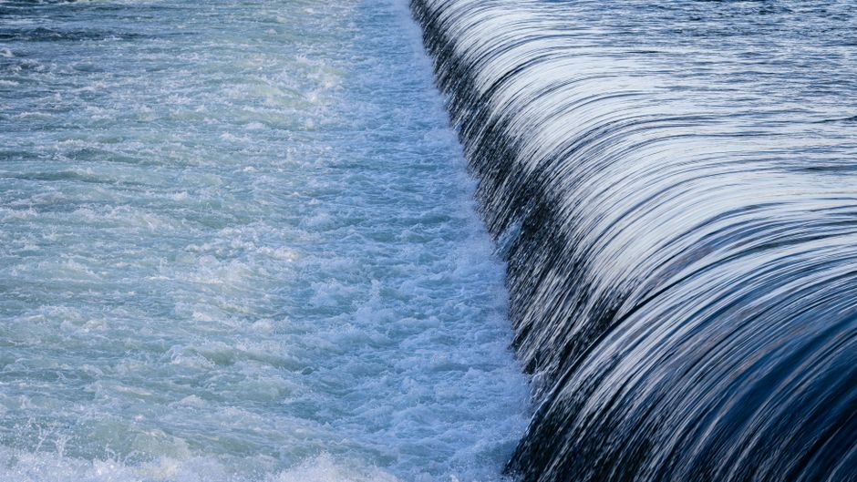 A tranquil scene of a flowing waterfall in motion, showcasing its power and beauty.