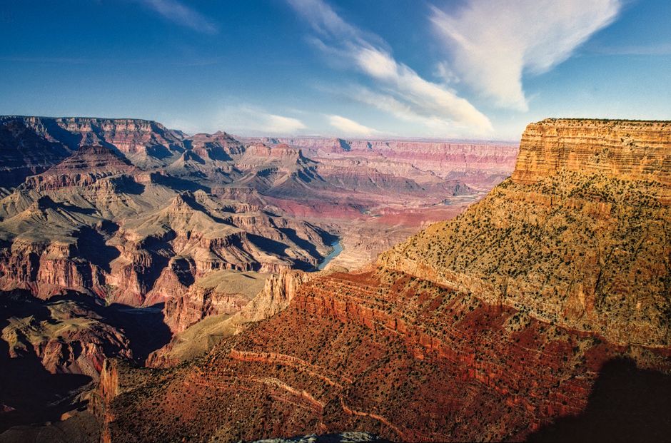 Stunning aerial perspective of the majestic Grand Canyon under a clear blue sky