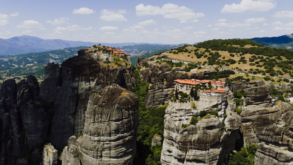 Stunning aerial shot of Meteora monasteries perched on rocky cliffs in Greece's landscape