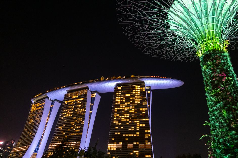 Stunning nighttime view of Marina Bay Sands hotel with illuminated Supertree in Singapore