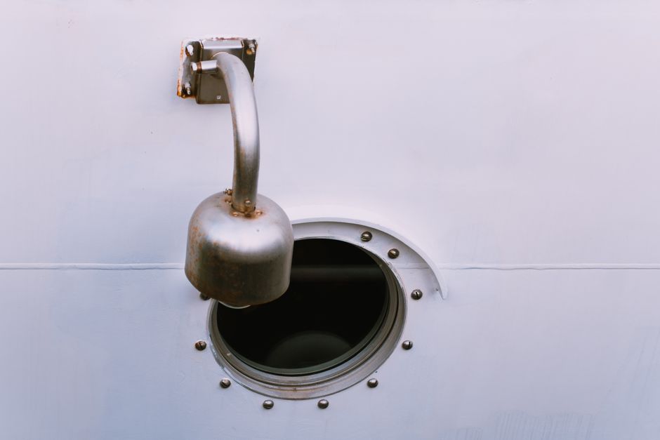 A detailed view of a ship's porthole and vent, showcasing maritime design elements.
