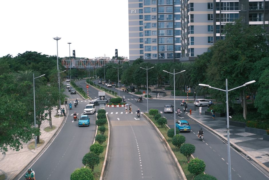 A busy intersection in a modern city with vehicles and buildings.