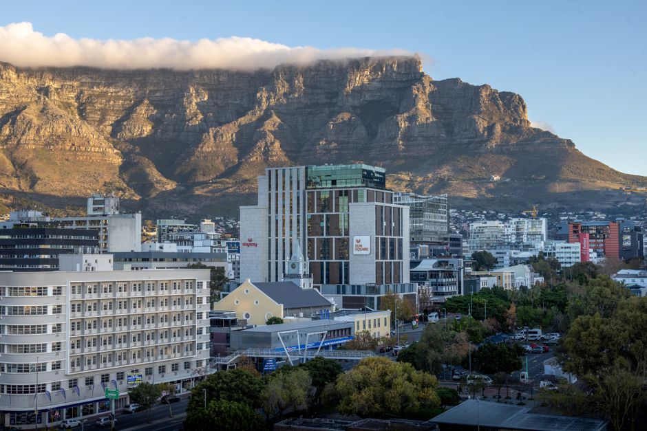 Urban view of Cape Town with Table Mountain at sunrise, capturing the city's architecture