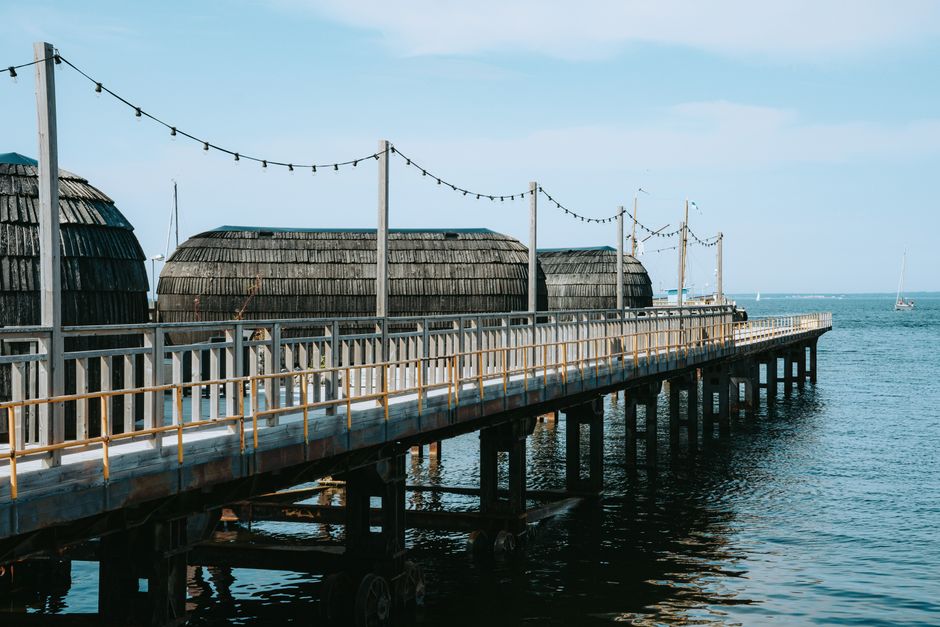 Explore the serene waterfront and traditional structures in Tallinn, Estonia, on a bright summer day.